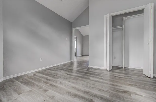 a view of a room with wooden floor