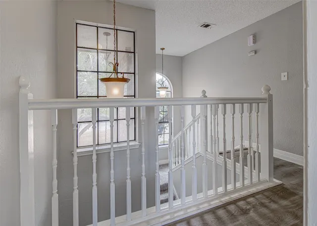 a view of staircase with white walls and window