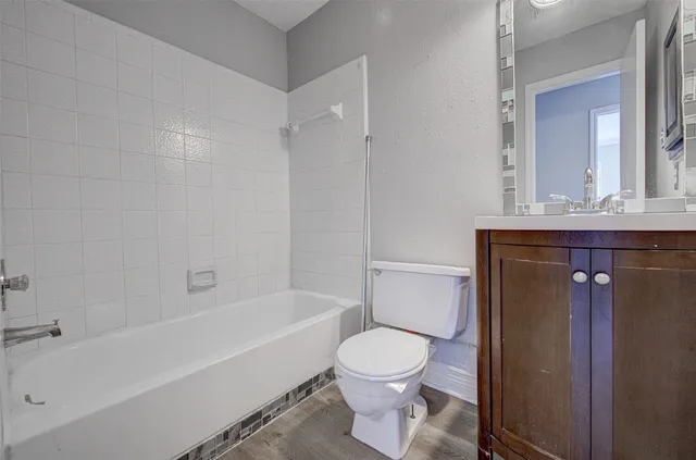 a bathroom with a toilet a sink and bathtub