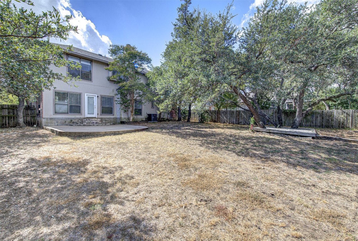 1401 Deepwoods Trail Leander, TX 78641 - Photo 33 of 34 a view of a house with a yard