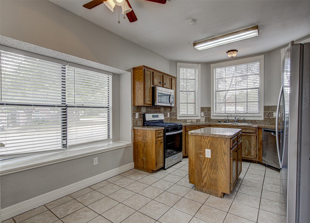 1401 Deepwoods Trail Leander, TX 78641 - Photo 4 of 34 a kitchen with a refrigerator and a stove top oven
