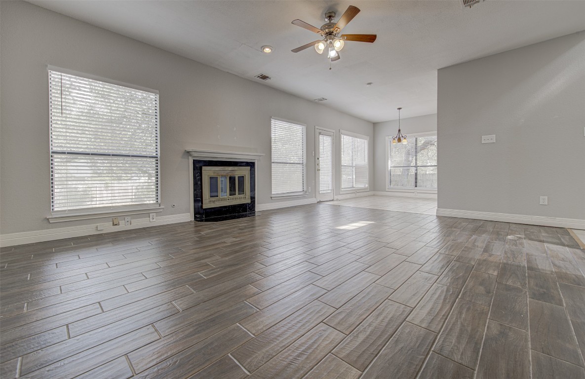 1401 Deepwoods Trail Leander, TX 78641 - Photo 10 of 34 a view of an empty room with a window and wooden floor