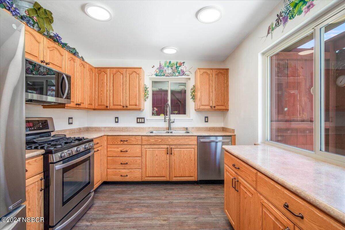 313 Somerset Place Lompoc, CA 93436 - Photo 12 of 59 a kitchen with granite countertop a sink stainless steel appliances and cabinets