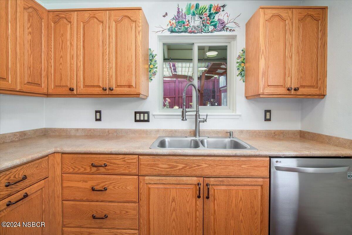 313 Somerset Place Lompoc, CA 93436 - Photo 13 of 59 a kitchen with stainless steel appliances granite countertop a sink and dishwasher with cabinets
