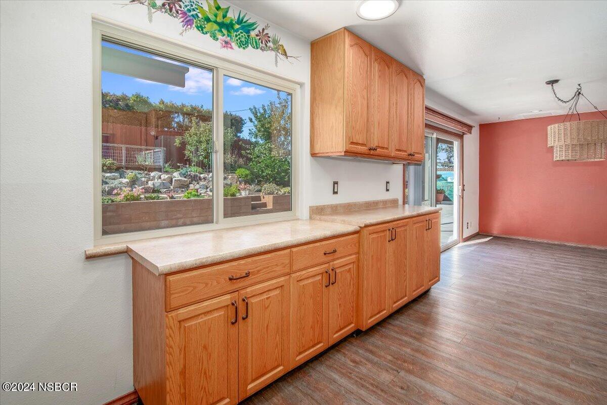 313 Somerset Place Lompoc, CA 93436 - Photo 15 of 59 a kitchen with granite countertop wooden cabinets a sink and a large window