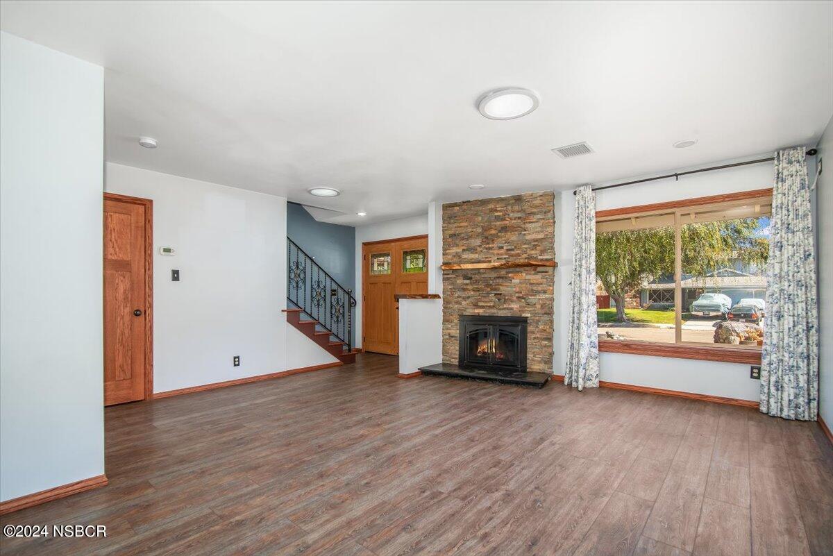 313 Somerset Place Lompoc, CA 93436 - Photo 20 of 59 wooden floor fireplace and windows in an empty room