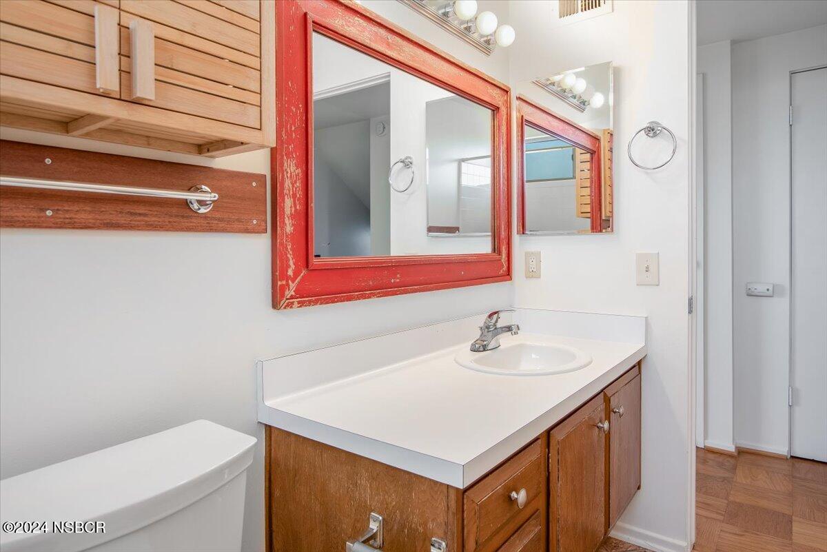313 Somerset Place Lompoc, CA 93436 - Photo 32 of 59 a bathroom with a sink a toilet and mirror