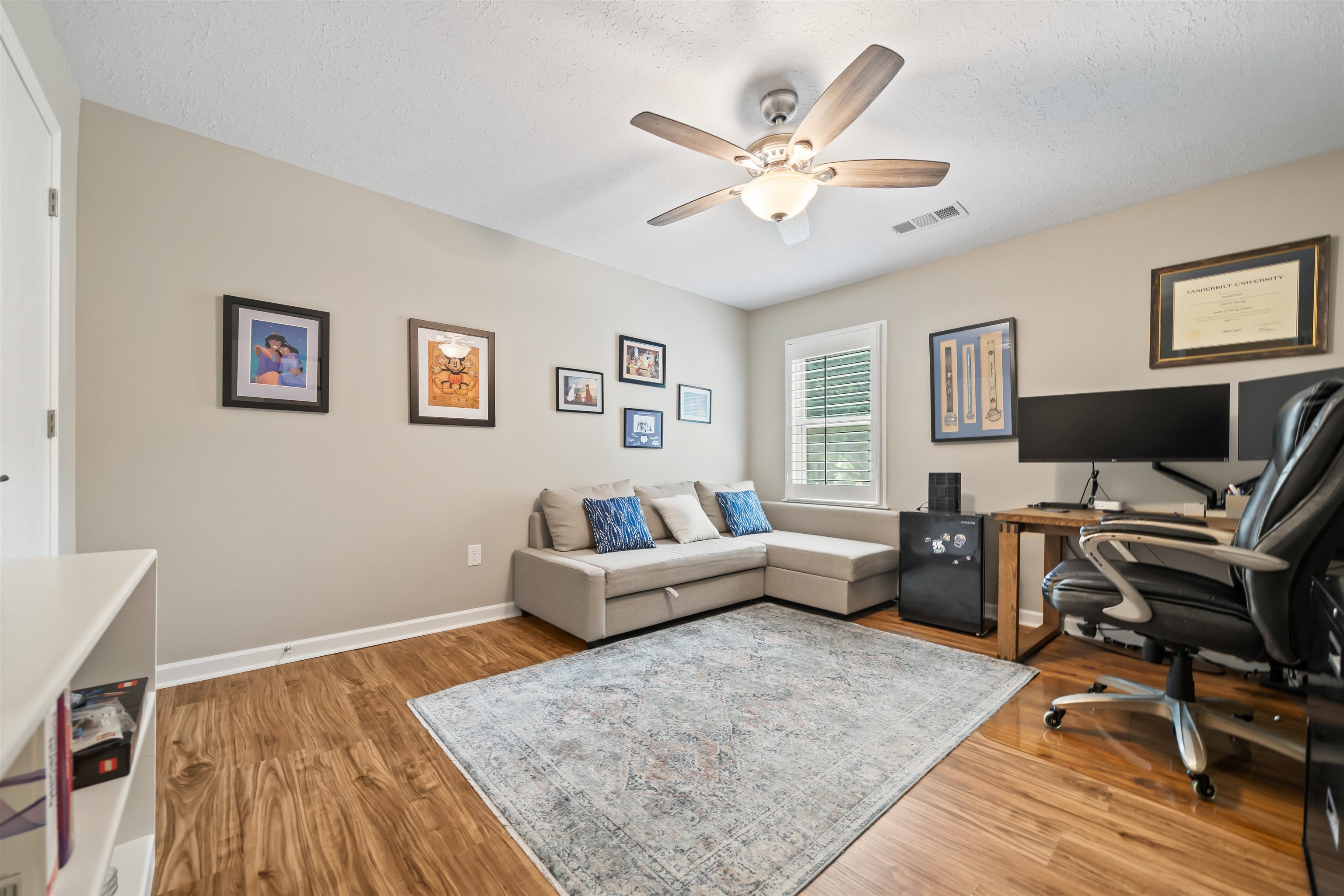 6943 Fords Station Road, Unit 64 Germantown, TN 38138 - Photo 28 of 30 Well-lit room featuring wood-finish flooring, a ceiling fan with integrated lighting, and a window with white louvered blinds