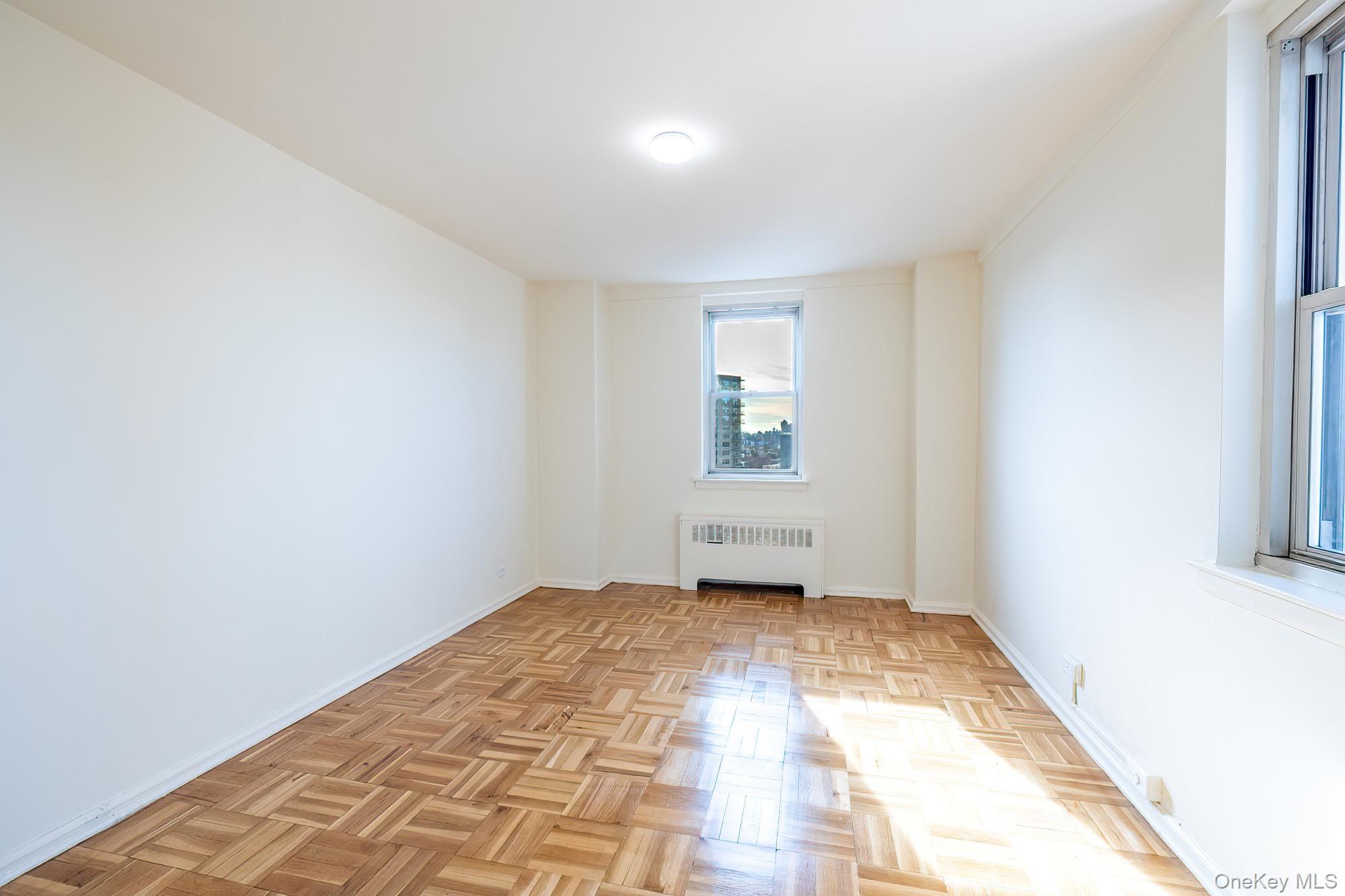 25 Knolls Crescent, Unit 8L Bronx, NY 10463 - Photo 13 of 21 Spare room with radiator heating unit and baseboards
