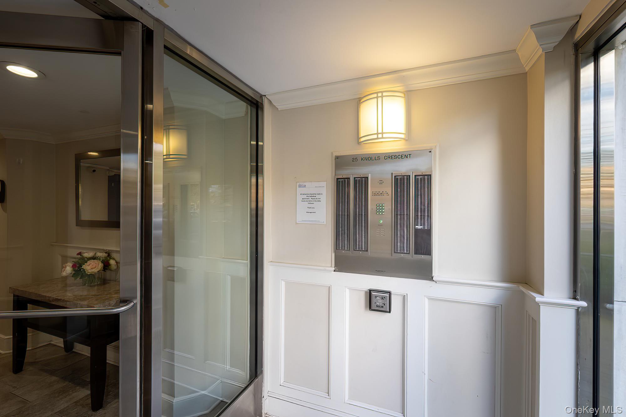 25 Knolls Crescent, Unit 8L Bronx, NY 10463 - Photo 16 of 21 Bathroom with crown molding, a shower stall, and a decorative wall