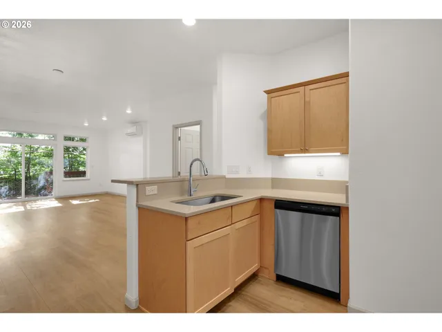 a kitchen with a sink cabinets and wooden floor