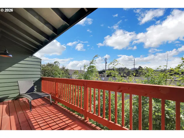 a view of balcony with wooden floor