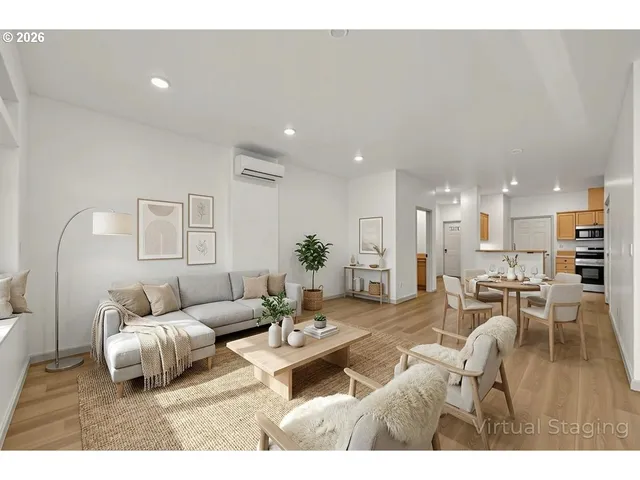 a living room with furniture a wooden floor and a chandelier