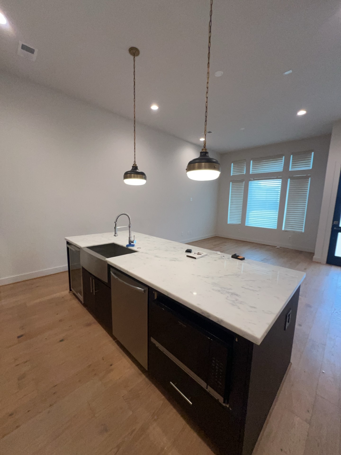 2414 Gray Street Houston, TX 77003 - Photo 4 of 14 a kitchen with kitchen island a sink stainless steel appliances and a chandelier