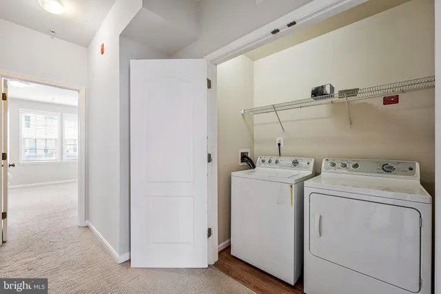 a view of storage and utility room with dryer and washer