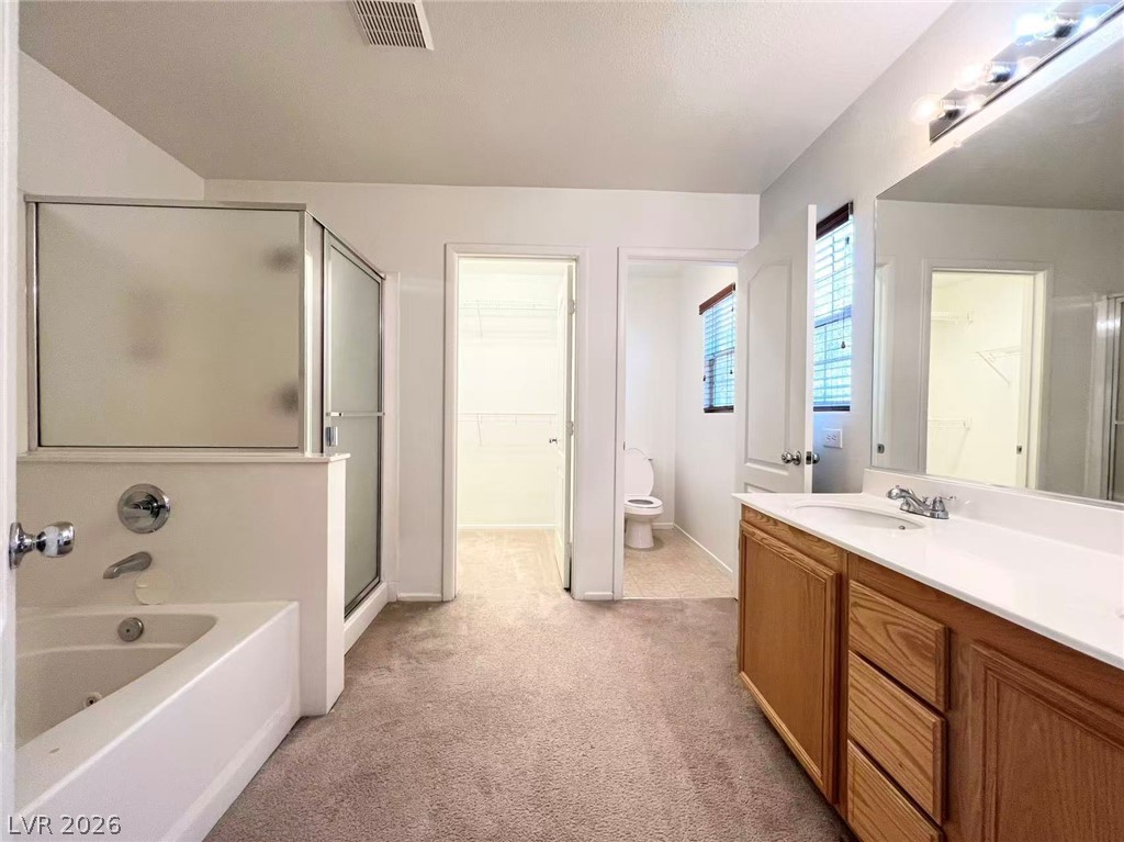 11143 Ranch Valley Street Las Vegas, NV 89179 - Photo 16 of 23 A well-appointed bath offers a separate soaking tub and shower, plus ample vanity space.