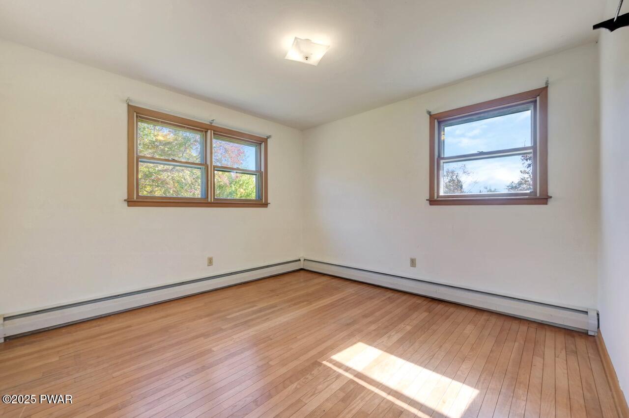100 Spring Hill Road Moscow, PA 18444 - Photo 40 of 101 a view of an empty room with wooden floor and a window