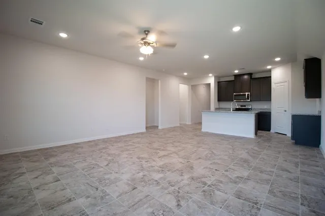 a view of a kitchen with a sink cabinets and stainless steel appliances