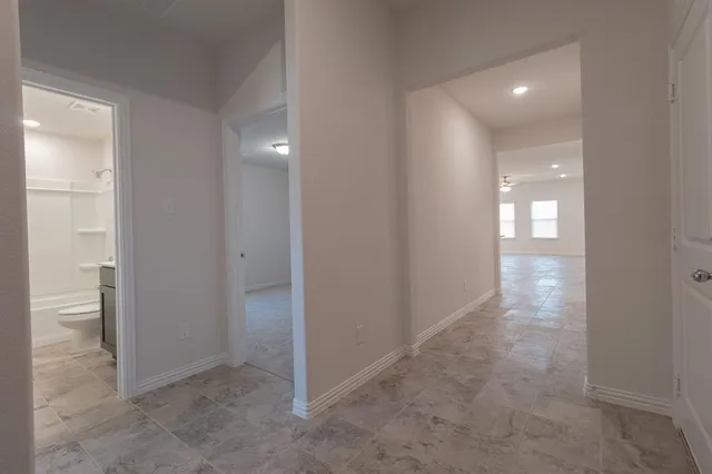 an empty room view with wooden floor and windows