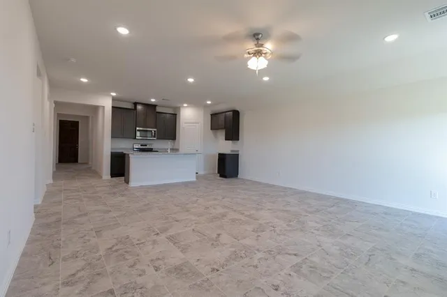 a view of a kitchen with a sink and a refrigerator