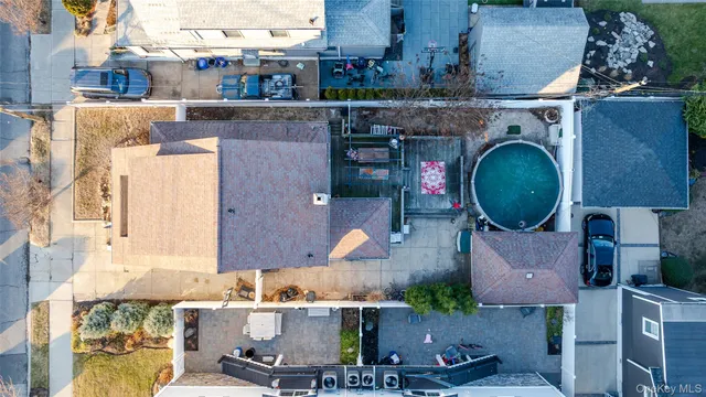 an aerial view of a house with outdoor space and a patio