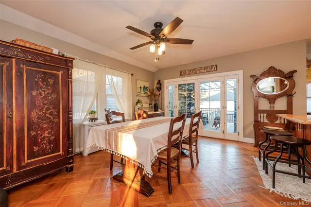 a dining room with furniture window and wooden floor
