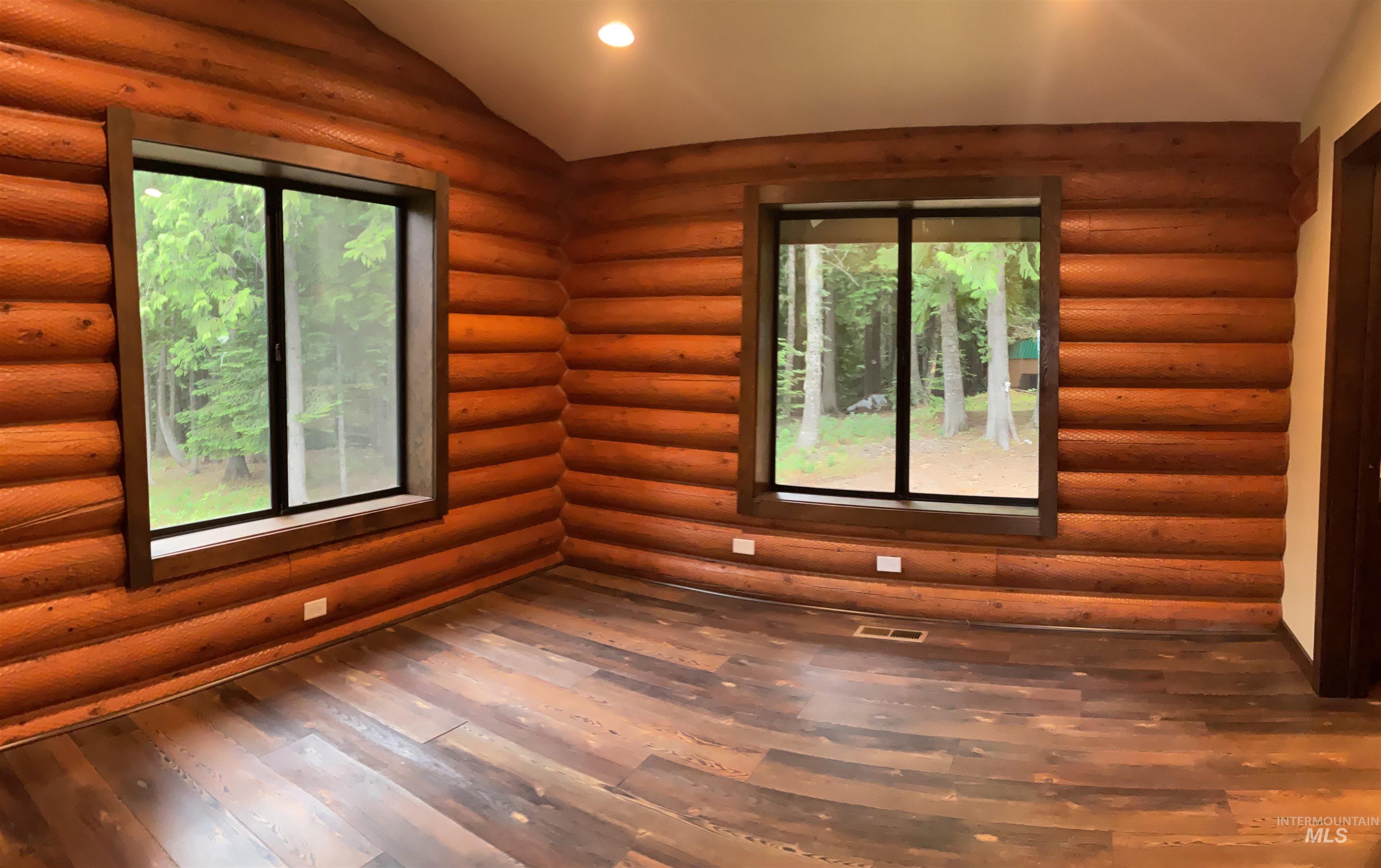 6125 Freeman Creek Road Lenore, ID 83541 - Photo 16 of 44 Interior room featuring prominent log-style walls and wood-finish flooring