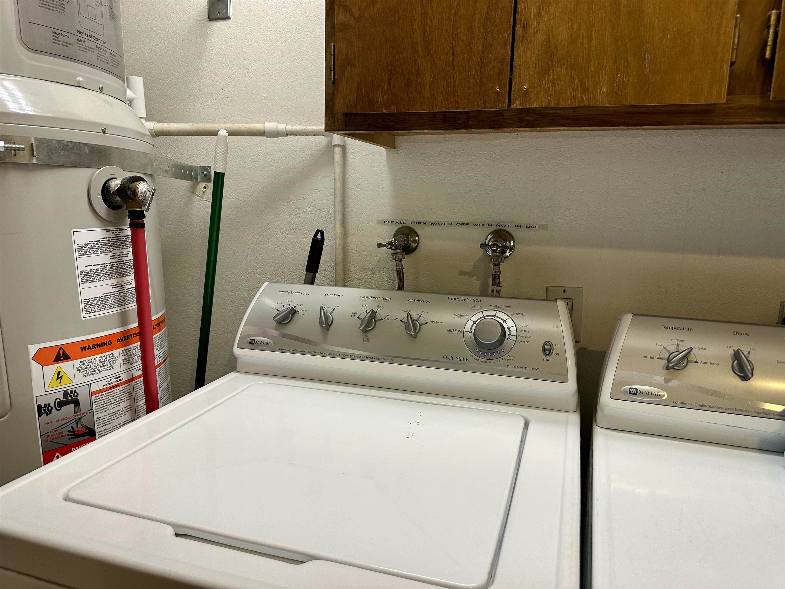 315 Fascination, Unit 315 Mammoth Lakes, CA 93546 - Photo 12 of 44 Dedicated laundry area featuring a top-load washing machine and dryer, alongside a water heater