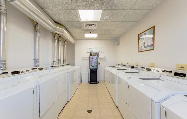 a large white kitchen with a stove and a sink