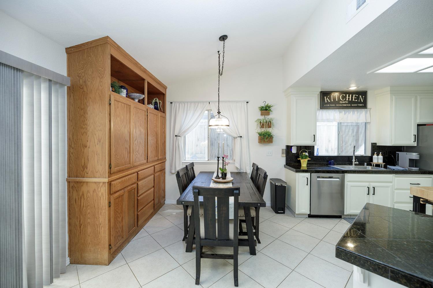 230 Meyenberg Avenue Ripon, CA 95366 - Photo 22 of 52 a kitchen with refrigerator cabinets and chairs