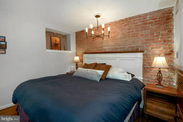 a bedroom with a bed and a fireplace