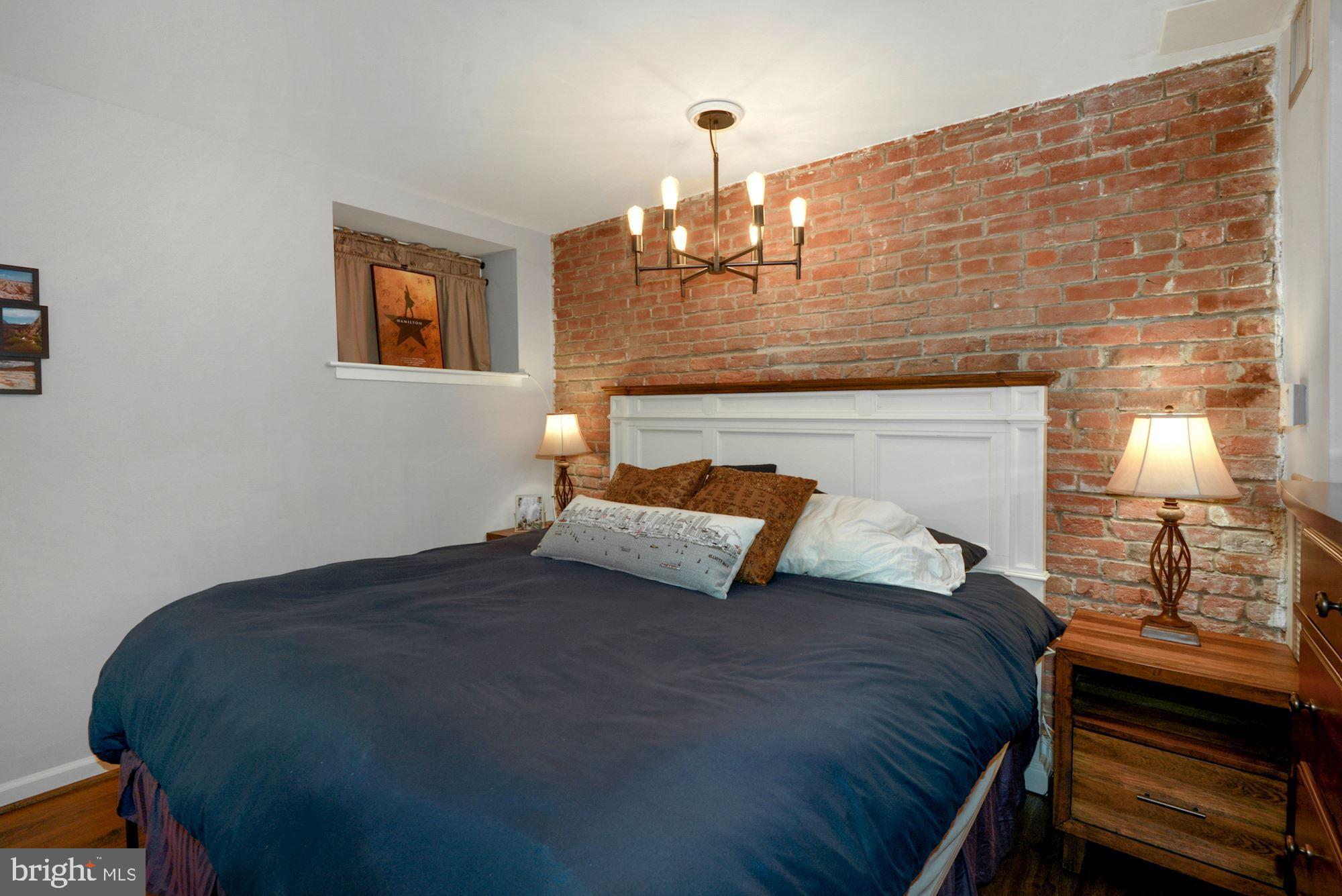 1718 Corcoran Street Northwest, Unit 5 Washington, DC 20009 - Photo 13 of 23 a bedroom with a bed and a lamp on table