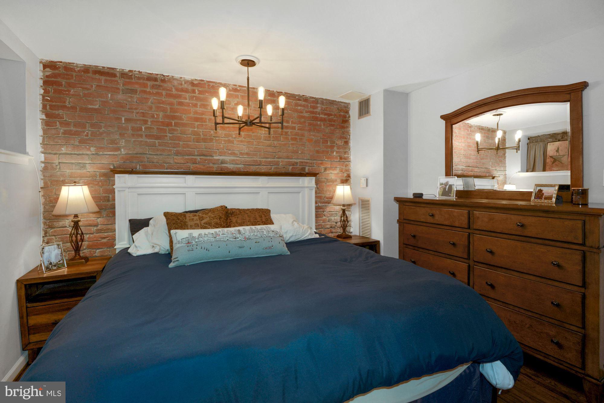 1718 Corcoran Street Northwest, Unit 5 Washington, DC 20009 - Photo 14 of 23 a bedroom with a bed and a fireplace