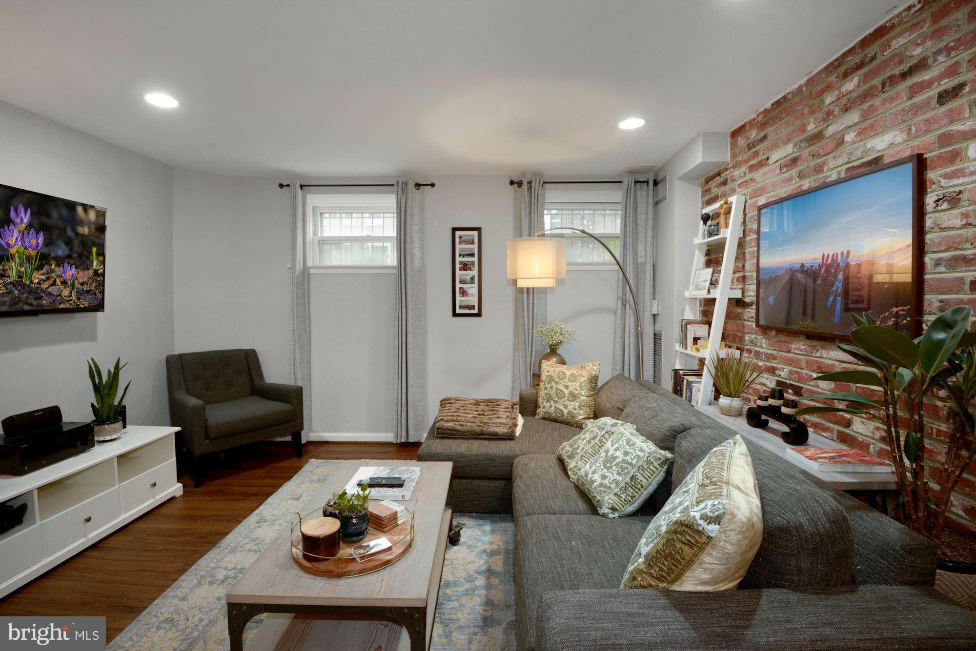 1718 Corcoran Street Northwest, Unit 5 Washington, DC 20009 - Photo 16 of 23 a living room with furniture and wooden floor