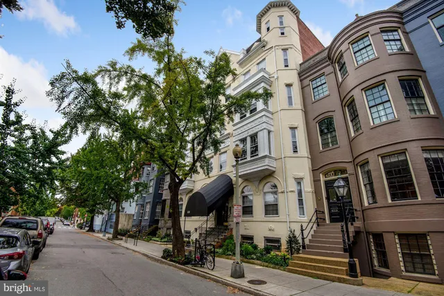 a front view of a residential apartment building with a yard