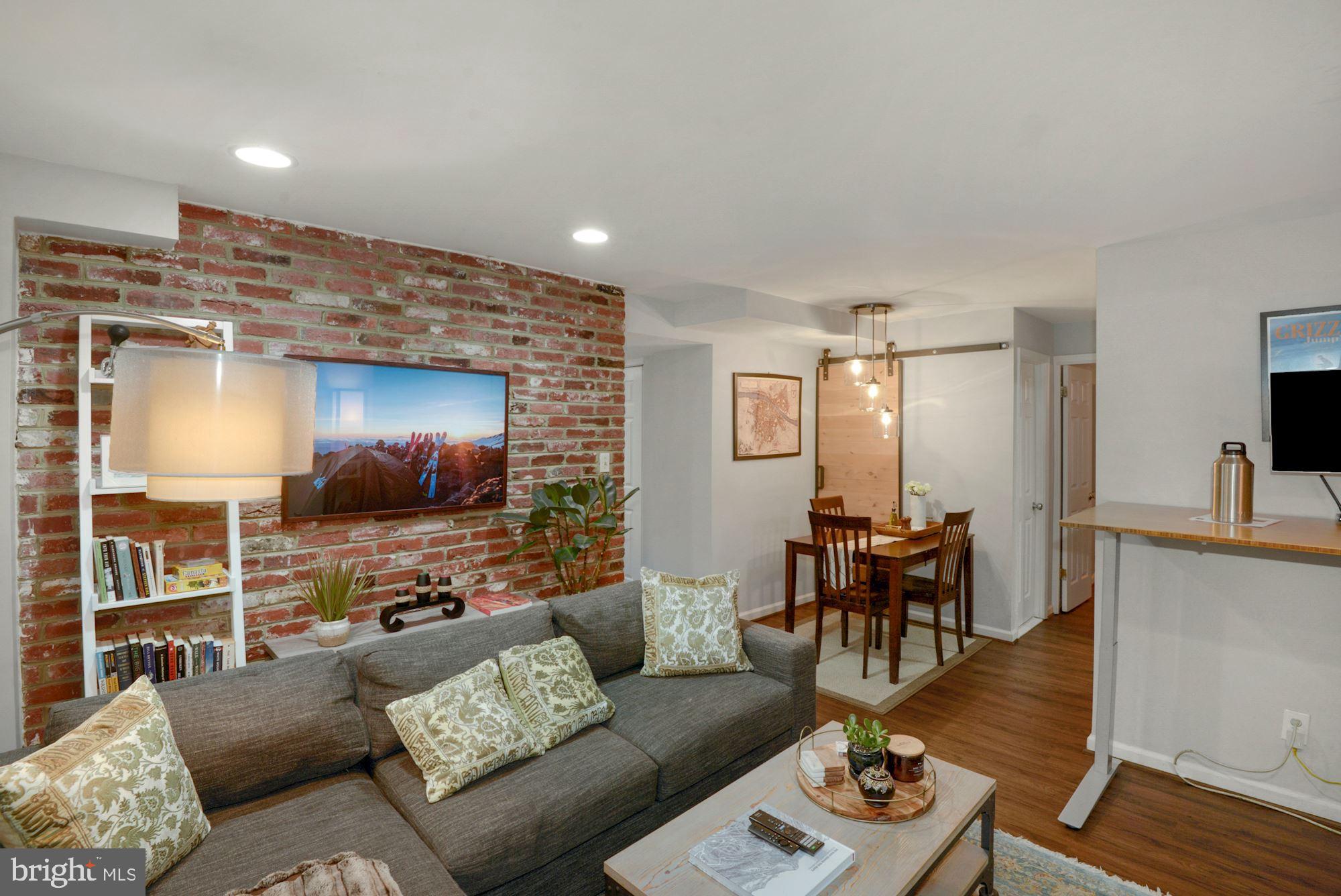 1718 Corcoran Street Northwest, Unit 5 Washington, DC 20009 - Photo 9 of 23 a living room with furniture and a flat screen tv