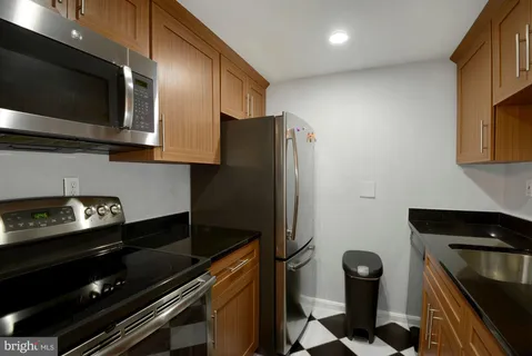a kitchen with stainless steel appliances granite countertop a refrigerator and a sink