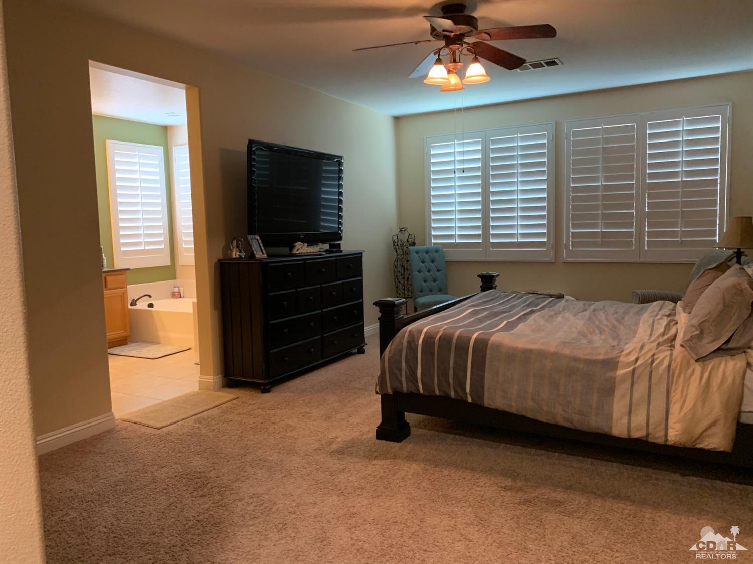 37503 Haweswater Road Indio, CA 92203 - Photo 9 of 19 a bedroom with a bed and a flat screen tv