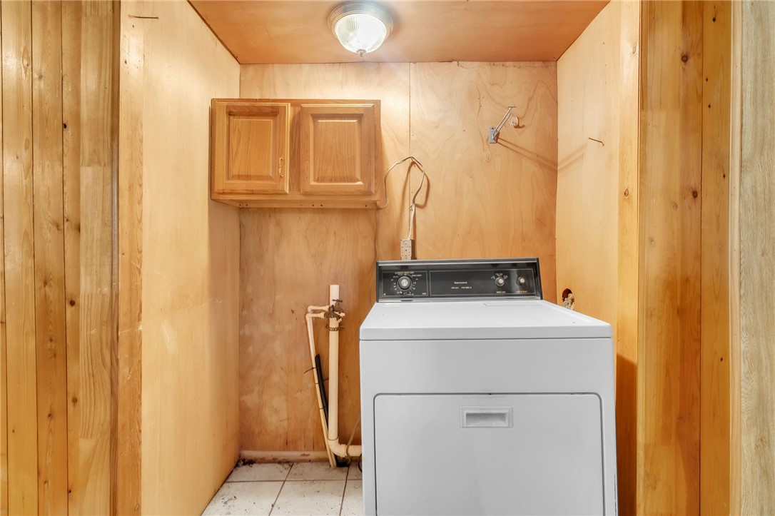 602 Harper Road Pendleton, SC 29670 - Photo 24 of 32 A dedicated utility space with wooden paneling and practical cabinetry provides convenient laundry facilities.