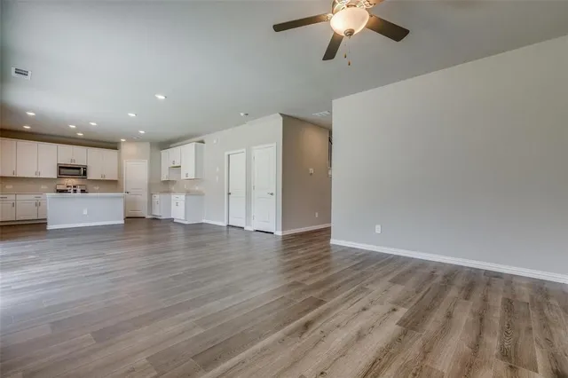 a view of kitchen with cabinets and wooden floor