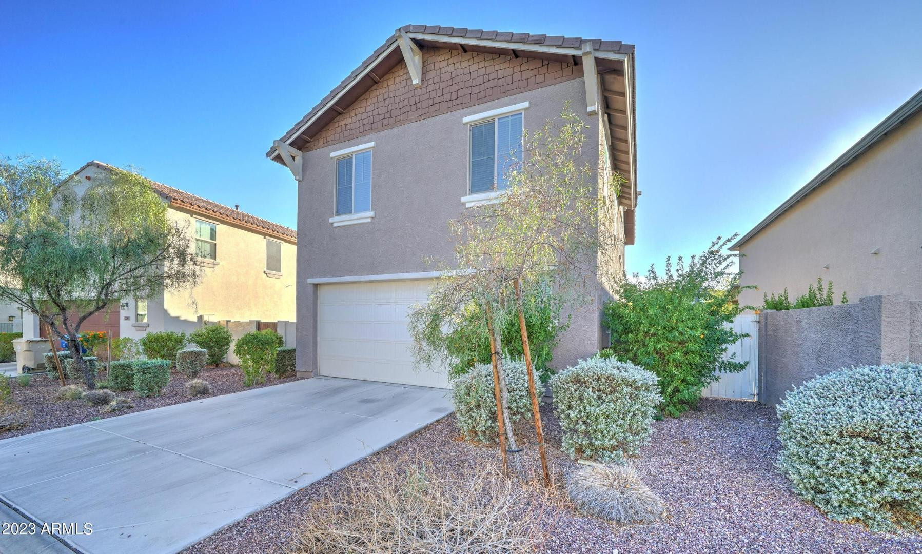 2297 North Alsap Road Buckeye, AZ 85396 - Photo 32 of 36 a front view of a house with garden