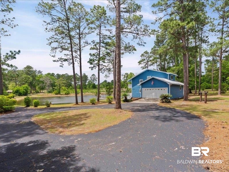 3160 Old Castleberry Road Brewton, AL 36426 - Photo 23 of 36 Two-story blue siding residence with an attached two-car garage