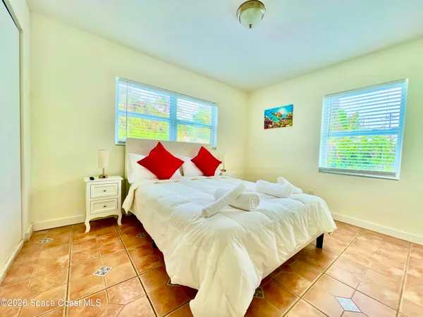 a bedroom with a bed and a painting on the wall