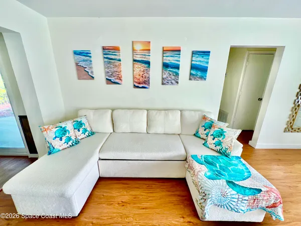 a living room with furniture and flowers