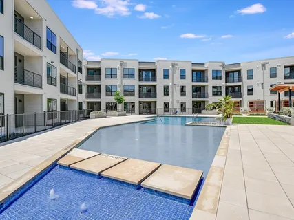 a view of pool with building and dining space