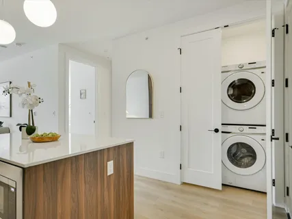 a view of a storage and utility room with washer and dryer