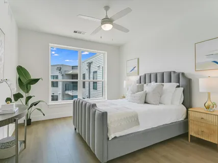 a bedroom with a balcony a bed and a chandelier