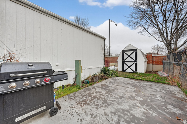262 Hidden View Drive, Unit 94 Sandy, UT 84070 - Photo 17 of 18 View of patio / terrace featuring grilling area and a storage shed