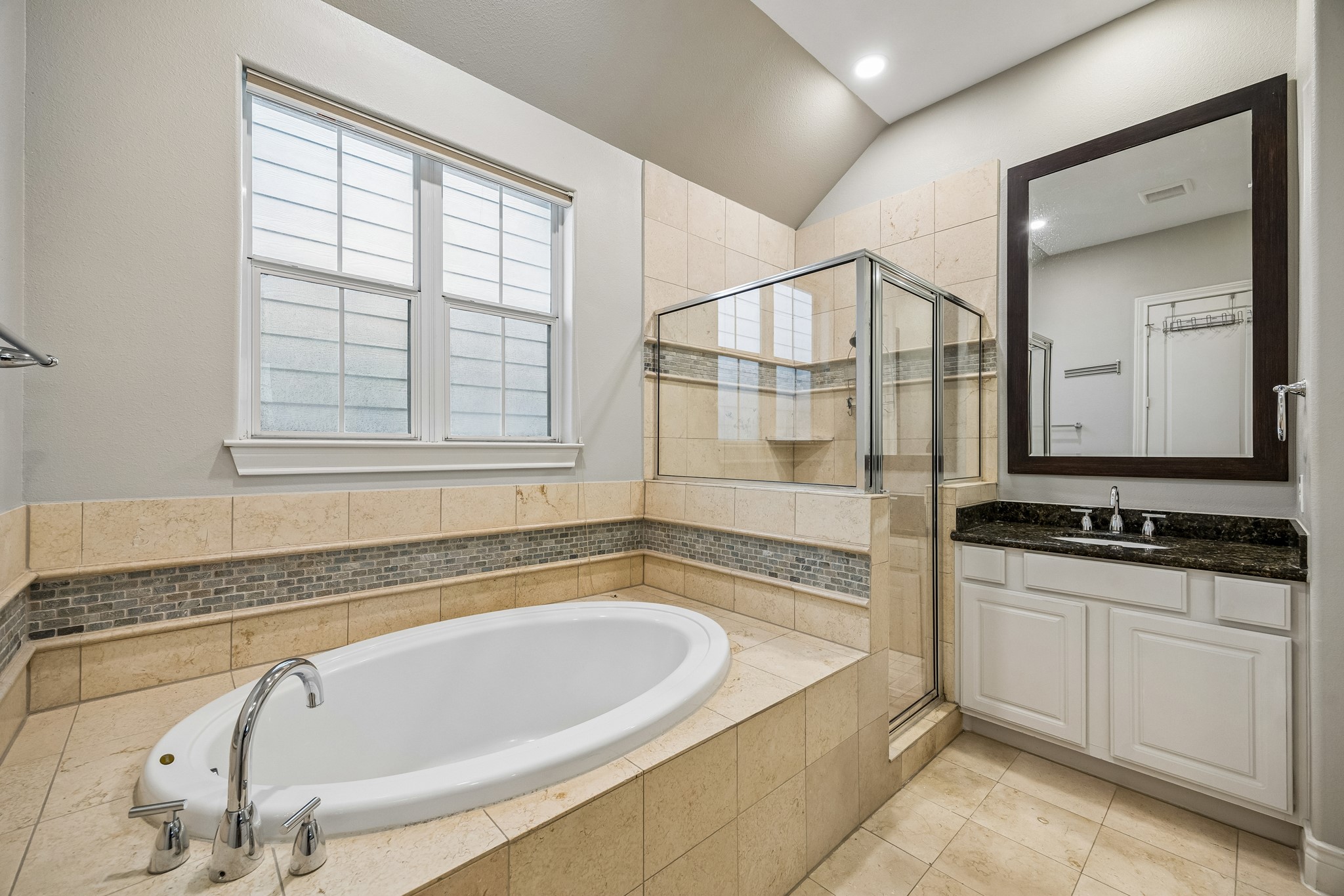 622 Rutland Street, Unit D Houston, TX 77007 - Photo 13 of 27 Primary bathroom with soaking tub, separate glass-enclosed shower, and dual vanities. Tile flooring and surround add a clean, timeless look. Ample counter space and storage make this a highly functional retreat.