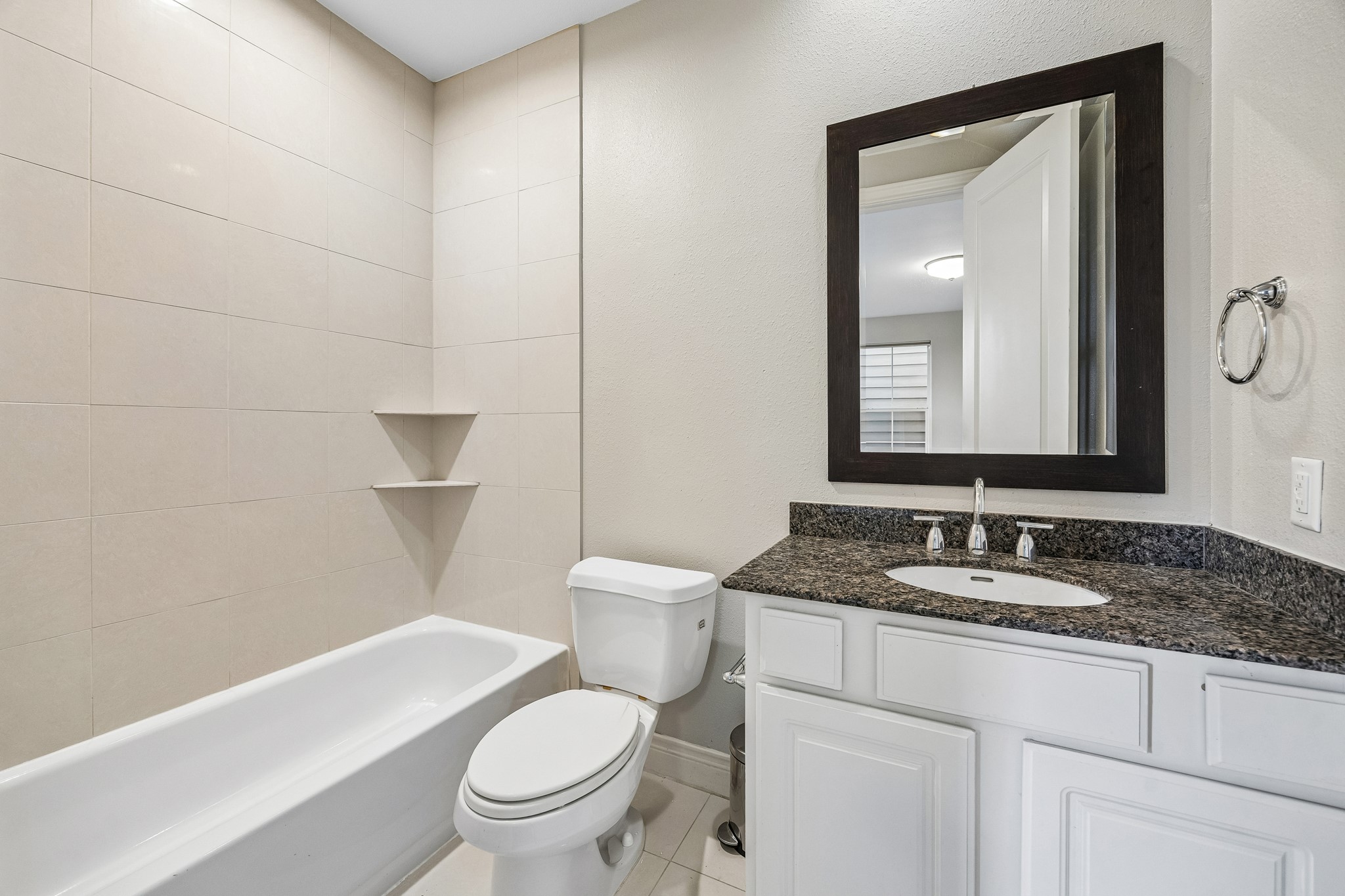 622 Rutland Street, Unit D Houston, TX 77007 - Photo 16 of 27 Secondary bathroom with tiled shower/tub combo and modern fixtures. Neutral finishes provide a versatile and move-in ready space. Thoughtfully designed for both style and function.